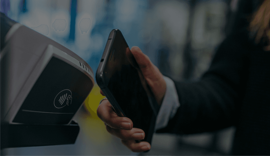 a phone taps a tap payment machine